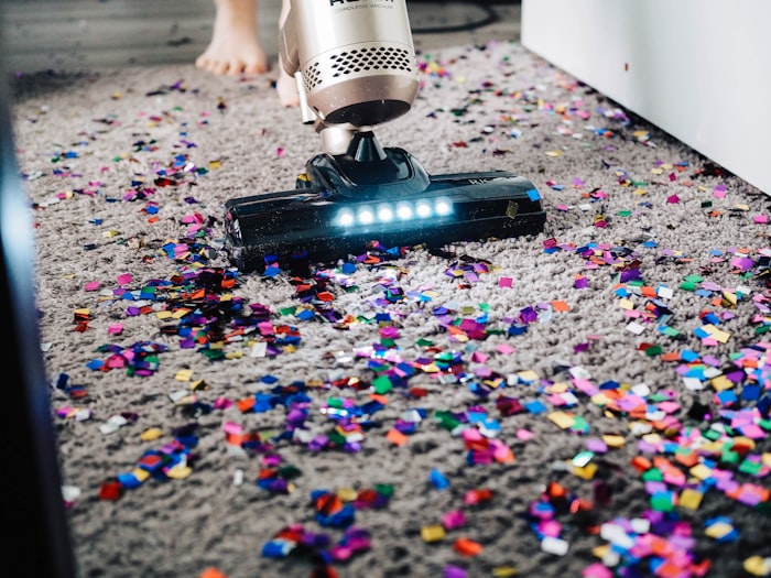 Housekeeper dusting a living room